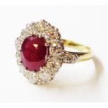 An unmarked high carat yellow metal ring, set with central 1.25ct. oval ruby within a ten stone