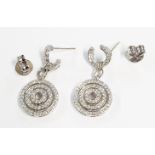 A pair of hallmarked 750 white gold ear-rings, each with diamond set concentric band drops on C-