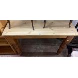 A 1.06m modern pine scrub-top kitchen table, set on turned legs