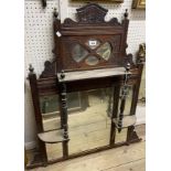 An Edwardian walnut overmantel mirror with multiple bevelled plates, flanking shelves and turned