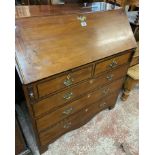 A 95cm late Georgian mahogany and ebony strung bureau with fitted interior over two short and