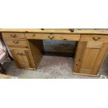 A 1.51m modern pine kneehole desk with short drawers, flanking file drawer and cupboard