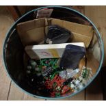 A tin containing a quantity of assorted collectable items including enamel medals, costume