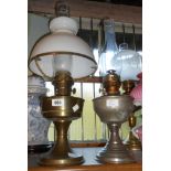 An old brass oil lamp with chimney and white opaque glass shade - sold with a similar plated example
