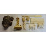 A bag containing a Chinese cellulose figurine and other carved bone examples - sold with an