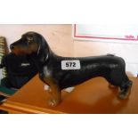 A modern cast metal dachshund form door stop