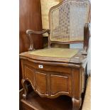 An old mahogany framed commode elbow chair with rattan back and seat panels, set on cabriole legs