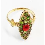 A yellow metal marquise panel ring, set with red and green stones