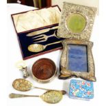 A box containing a small silver wine coaster with wooden base, damaged silver front photograph