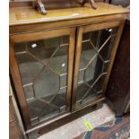 A 93cm 20th Century mahogany display cabinet with glass shelves enclosed by a pair of astragal