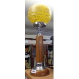 An Art Deco period phenolic and chrome table lamp with central amber coloured column, wooden base,