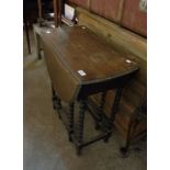 A small oak gateleg table with barley twist supports - in need of re-polishing