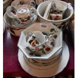A large selection of ceramic items decorated with cherries in the WeMyss style - various makers