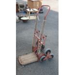 A red painted stair climbing sack barrow
