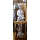 A large porcelaneous resin statue depicting a classical maiden with vase in original wooden