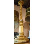 A large carved giltwood lamp of column form with fruiting spirals and acanthus terminal