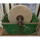 An old knife grinding wheel in wooden cradle
