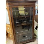 A 98cm antique mahogany freestanding corner cabinet enclosed by a beaded glazed panel door, set on
