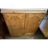 An 80cm modern pine two door cabinet