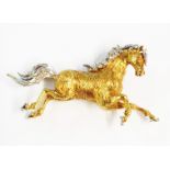 A 42mm yellow and white metal galloping horse pattern brooch with diamond encrusted mane and tail