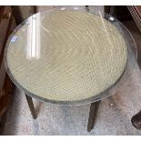 A Lloyd Loom style occasional table with 64cm diameter glass top, set on metal legs