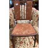An Edwardian mahogany and strung bedroom chair with upholstered panels