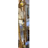 An antique brass telescopic lamp stan dard, set on heavy domed and reeded circular base -