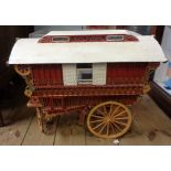 A large vintage scratch built wooden gypsy wagon with decorative detailing to exterior and interior