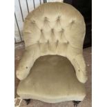 A late Victorian button back upholstered tub chair, set on turned front legs and casters