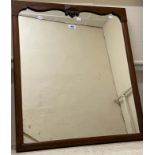 An antique rosewood framed wall mirror with shaped frame top and later oblong plate