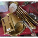 A selection of brass and other metal items including fire dogs, jug, trivet, etc.