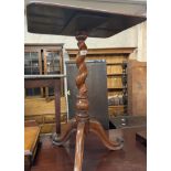 A Victorian stained walnut pedestal wine table with oblong top, set on barley twist pillar and