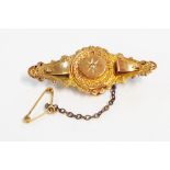 An old 9ct. gold ornate bar brooch