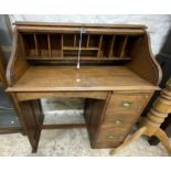 A 91cm vintage oak roll-top desk with part fitted interior enclosed by a tambour over slide and