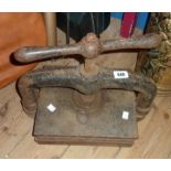 An antique cast iron book press with remains of original japanned finish