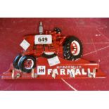 A modern cast metal McCormick Farmall tractor form key hook