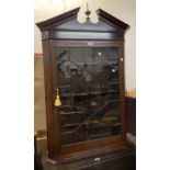 An 80cm 19th Century mahogany wall hanging corner cabinet with scalloped shelves enclosed by an