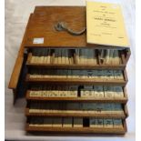 A boxed mahjong set in fitted wooden box with drawers containing tiles and sticks - rules booklet