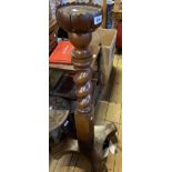 An antiqur mixed wood torchere with lotus style top and quatrefoil base with squat bun feet