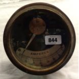 A large old industrial ammeter with brass and iron body