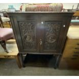 A 91cm Victorian carved oak cabinet with low raised back, pair of Romayne style panelled doors and