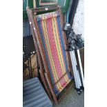 Two vintage similar folding deck chairs with stripped slung fabric