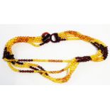 A multi-strand Art Deco style coloured amber necklace