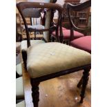 A set of four Regency rosewood framed dining chairs with upholstered seats, set on tulip carved
