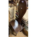 An antique stained mahogany hall boot chair with raised spoon back and drawer to side, set on square
