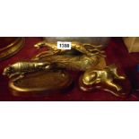 Three brass greyhound figurines, one given as a prize at Newton Abbot Greyhound Stadium, another