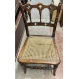 A late Victorian Gothic style stained wood framed bedroom chair with rattan seat panel