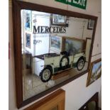 A stained wood framed reproduction Mercedes advertising wall mirror featuring a 1908 Edwardian