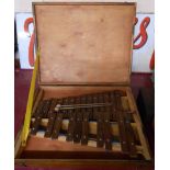 A vintage xylophone in original wooden case with mallets