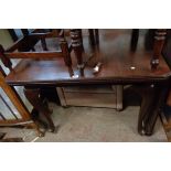 An early 20th Century stained walnut extending dining table with leaf and winder, set on cabriole